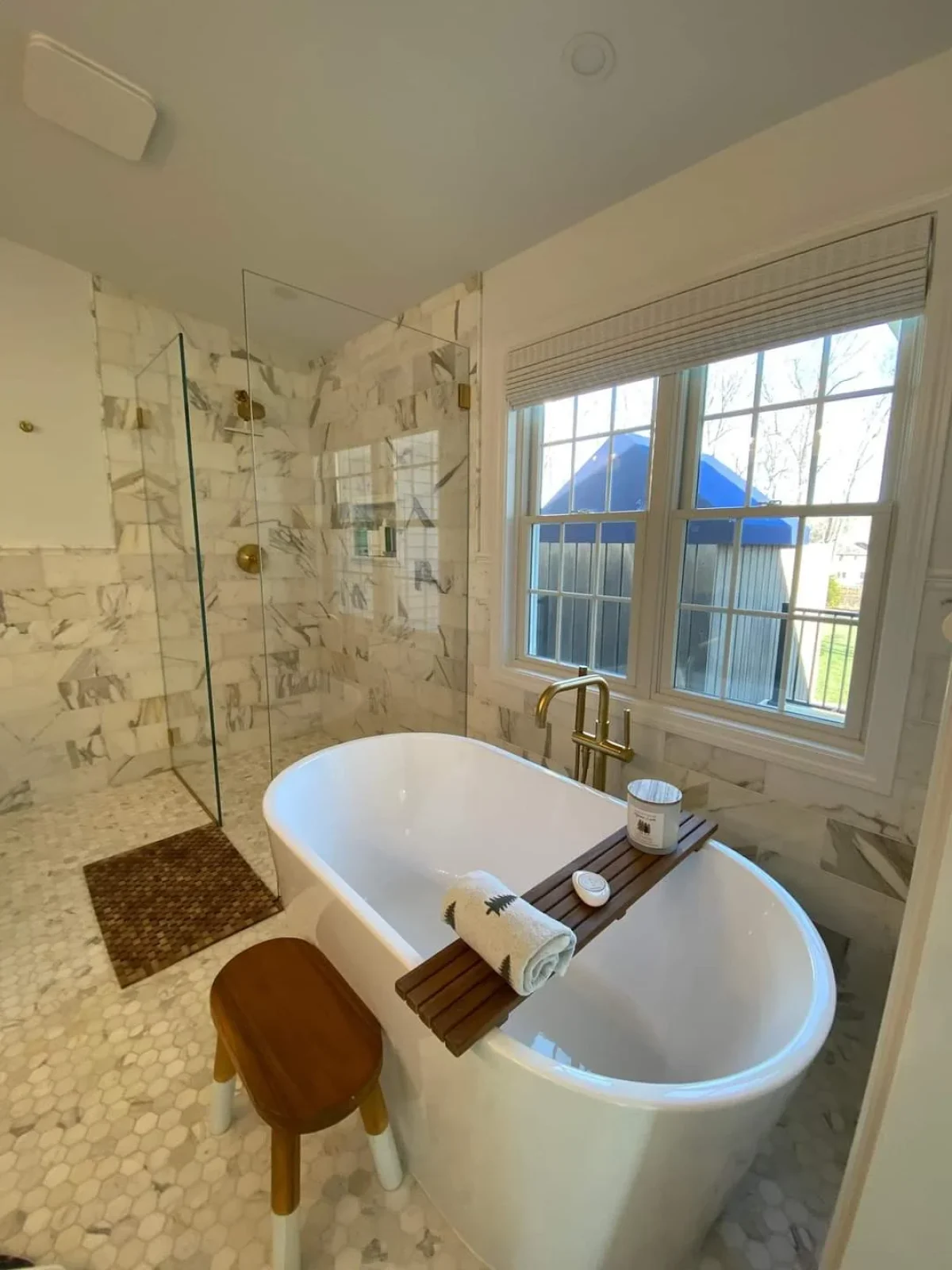 freestanding-bathtub-marble-tile-bathroom.webp