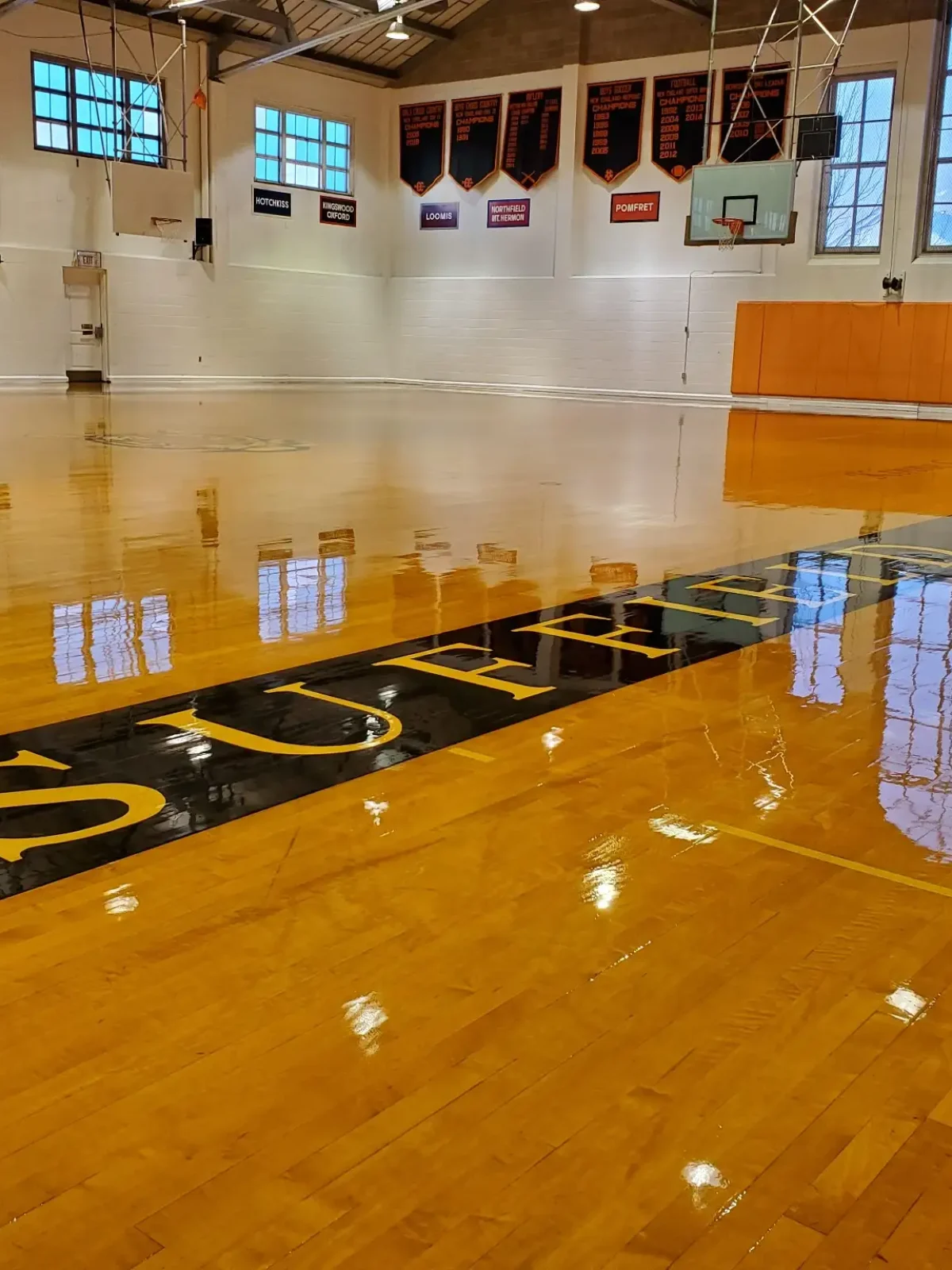 gymnasium-hardwood-floor-refinishing.webp